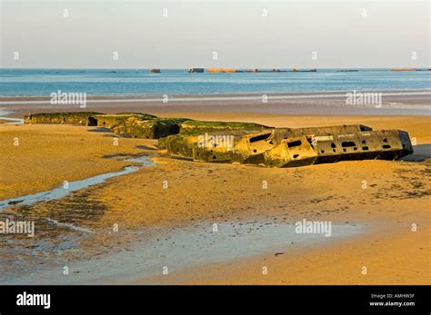 Arromanches les Bains beach with the remains of the Mulberry harbour in Normandy France Stock ...