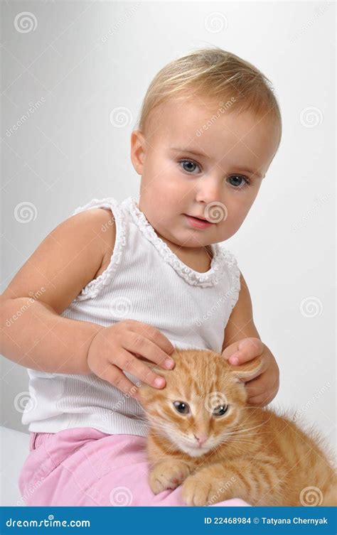 Baby playing with a kitten stock photo. Image of girl - 22468984