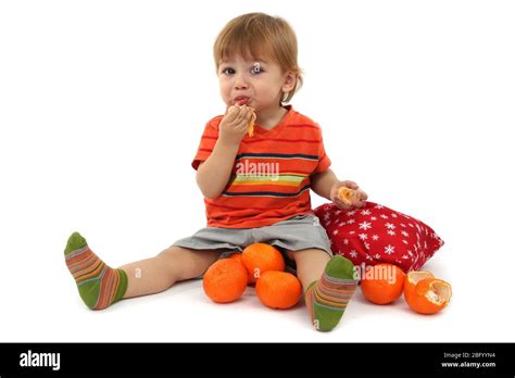 Cute Little Boy Eating Tangerines Isolated On White Stock Photo Alamy