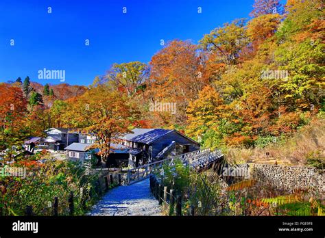 Rustic Ryokan Magoroku Onsen Among Colorful Autumn Forest With Blue Sky In Hot Spring Resorts Of