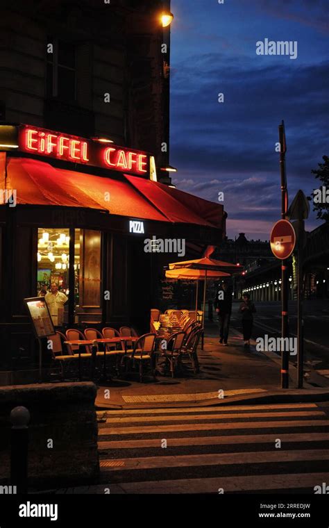 Eiffel Cafe Late Summer Evening Red Neon Sign Glowing Against The Blue