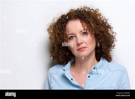 Close Up Portrait Of An Attractive Older Woman With Curly Hair Posing