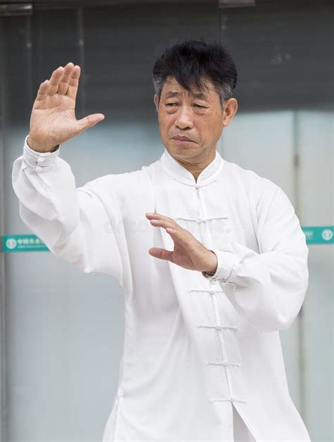 Chinese Master Practice Tai Chi On The Side Walk Of A Street Editorial