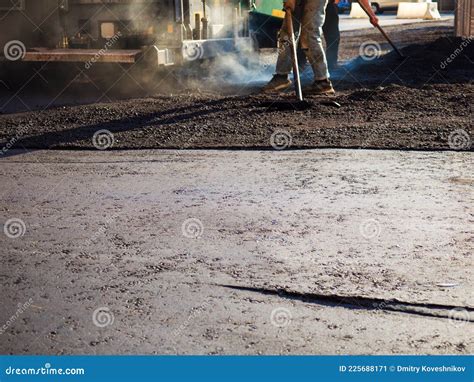 Laying New Asphalt The Process Of Leveling The Asphalt Manually Using