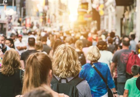 Crowd Of People Walking Down A Busy Street Min