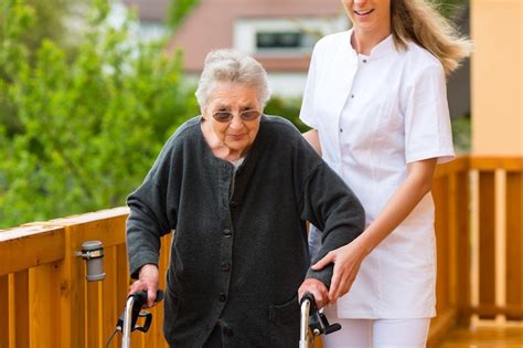 Premium Photo Young Nurse And Female Senior With Walking Frame