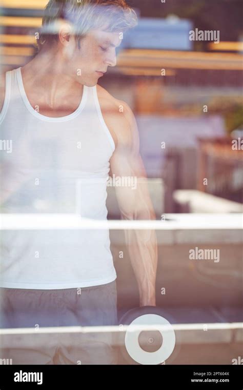 Taking Time To Workout Handsome Blonde Man Looking Away While Lifting