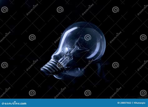 Light Bulb Floating On Water With Low Key Light Effect In Studio Stock