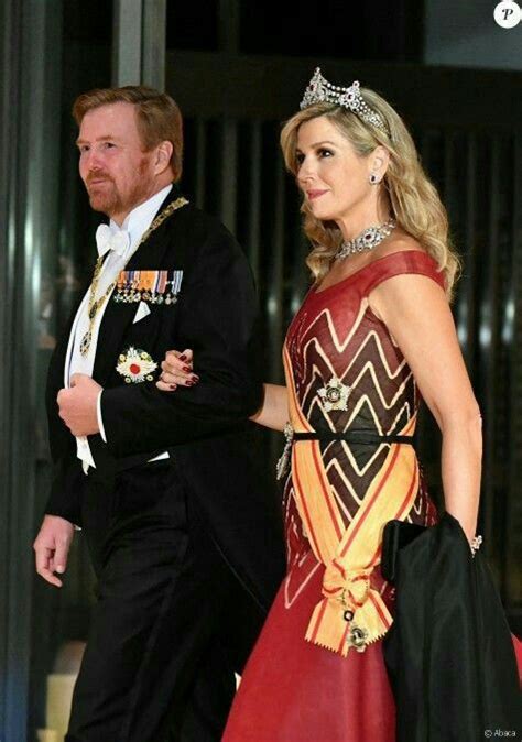 A Man And Woman In Formal Wear Walking Together