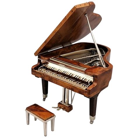 A Grand Piano With Stools And An Old Style Musical Instrument On It S Stand