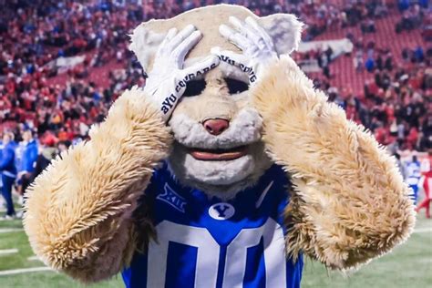 BYU mascot Cosmo Cougar makes an incredible jump over an equipment cart ...