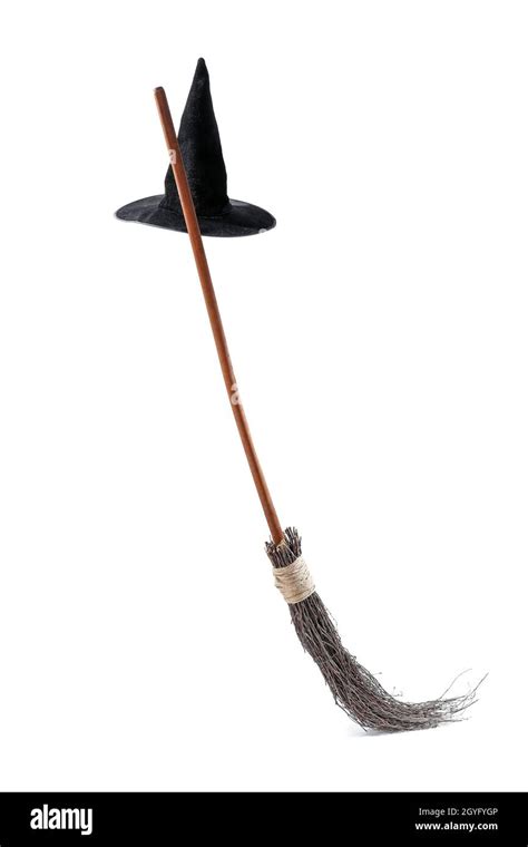 Witch hat and broom isolated on white Stock Photo - Alamy