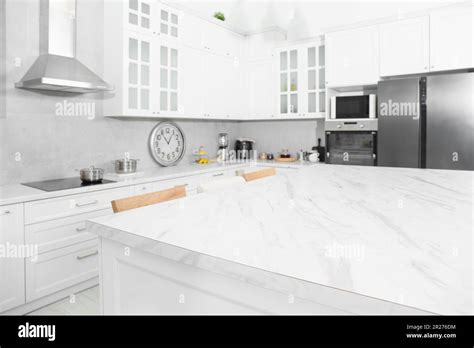 Stylish white marble table in kitchen. Interior design Stock Photo - Alamy