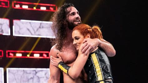 Becky Lynch And Seth Rollins Pose With Wwe Title Belts In Risqué Photo