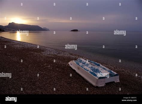 Boat On Pebble Beach Shortly After Sunrise On The Beach Of La Olla In