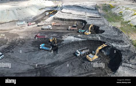 Excavators Working On Huge Mining Site Loading The Trucks Trucks