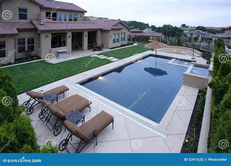 A Pool with a Waterfall in a Luxury Backyard Stock Image - Image of ...