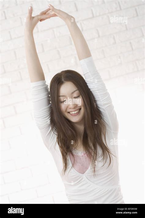 Woman Stretching Arms Above Head Stock Photo Alamy