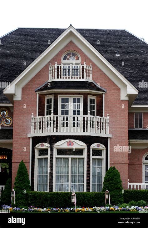 Colonial home with red brick white trim and black shingles with ...