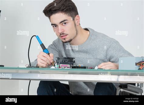 Young Man Holding Soldering Iron Stock Photo Alamy