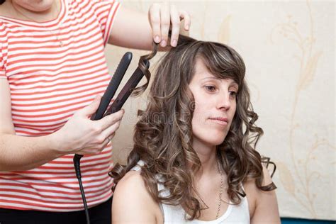 Hairdresser Curling Hair Strand Of Model With Flat Iron Domestic Room