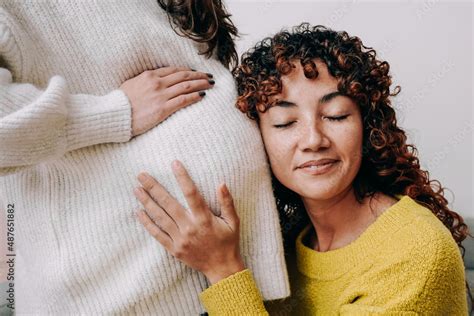 LGBT Lesbian Pregnant Woman Having Tender Moment Listening Her Wife Baby Belly Focus On Right