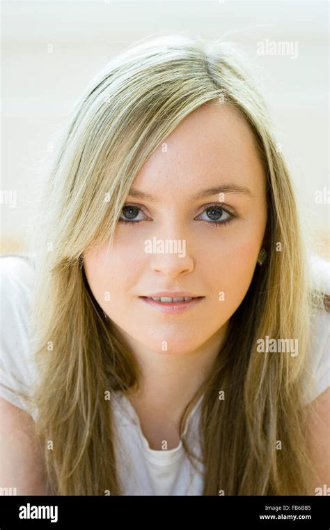 Head And Shoulder Shot Of Teenage Years Old Woman Facing With Eye Contact Long Blonde