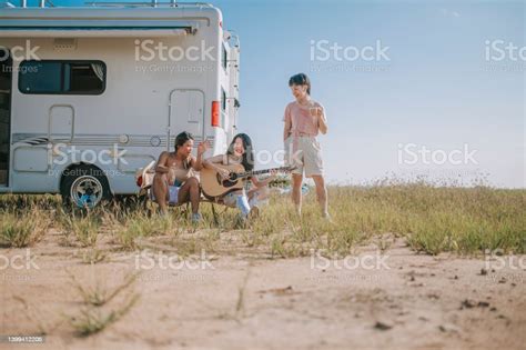 Asian Chinese Lesbian Couple And Friends Singing Dancing Playing Guitar