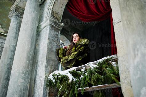 Brunette Girl In Green Fur Coat Against Old Arch With Columns And Red Curtains 8645882 Stock