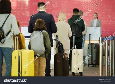 rear view people standing luggages queue stock photo
