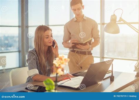 Side View Portrait Of Colleagues In Light Spacious Office Busy During