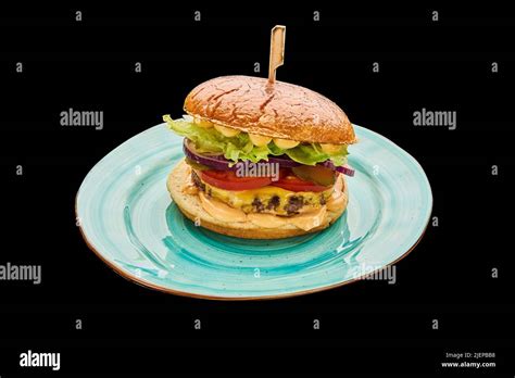 American Cheeseburger Isolated On A Black Background Stock Photo Alamy