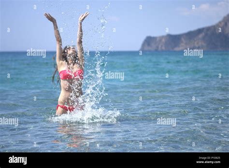 The Girl In The Red Bikini Is Splashing Water Stock Photo Alamy