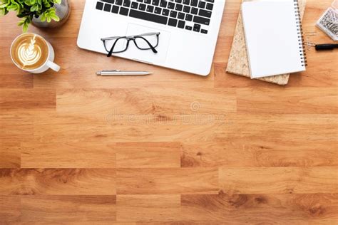 Wood Office Desk Table With Laptop Computer Cup Of Coffee And Supplies