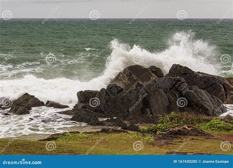 Angry Waves Crash Over Rocks On The Coast During A Summer Storm Stock