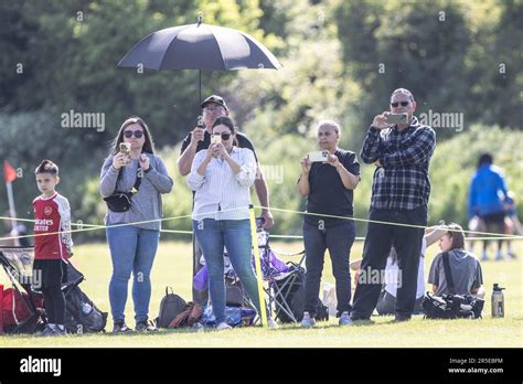 Parents Watching Children Play Grassroots Football Match And Filming