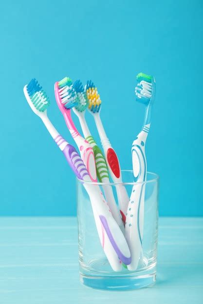 Premium Photo Toothbrushes In Glass Isolated