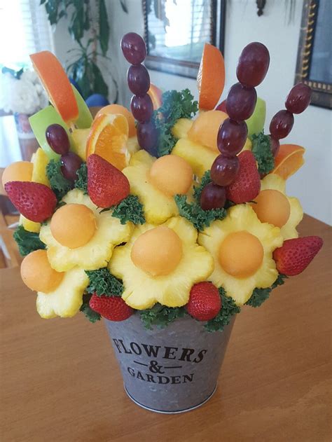 A Bucket Filled With Fruit Sitting On Top Of A Wooden Table