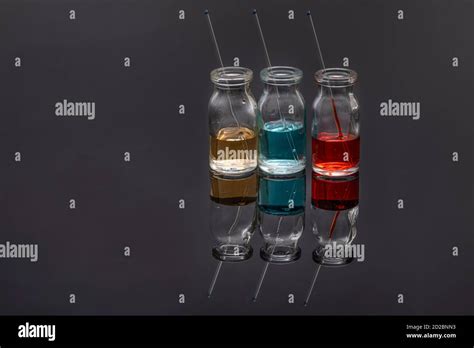 Glass Vials With Colored Medicine Liquid With Capillaries Red Yellow