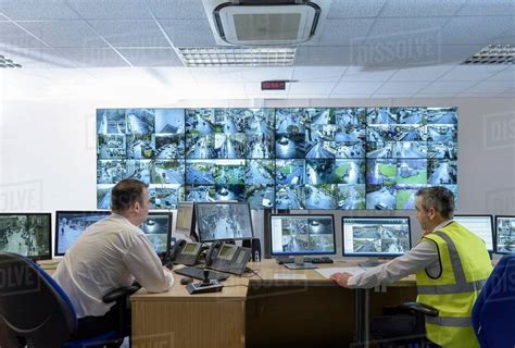 Security Guards In Security Control Room With Video Wall Stock Photo