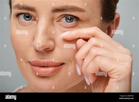 Joyous Good Looking Woman With Contact Lenses And Blonde Hair Looking