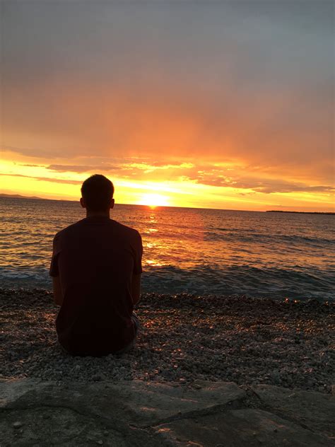 Man Watching Sunset On The Beach