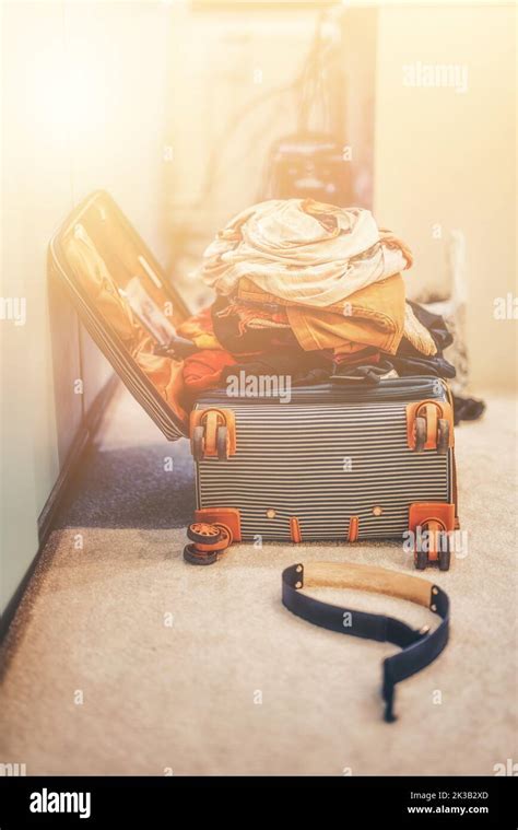 Open Suitcase Full Of Clothes In Room Stock Photo Alamy