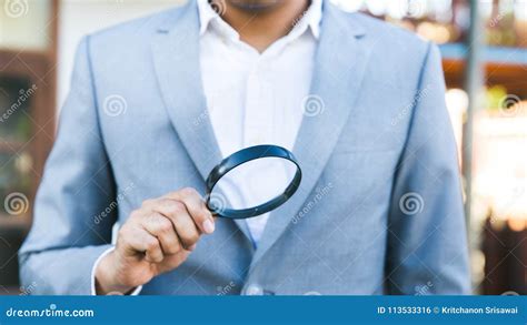 A Business Man Holding A Magnifying Glass Stock Photo Image Of Grey