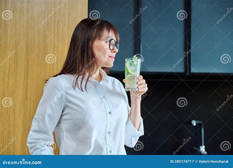 Mature Woman Drinking Glass Of Water With Lemon Ice Mint Stock Image
