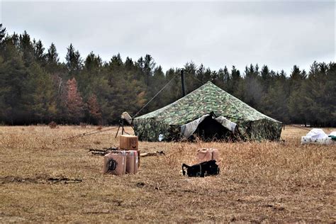 A raised Arctic 10-person tent is shown as students - NARA & DVIDS Public Domain Archive Public ...