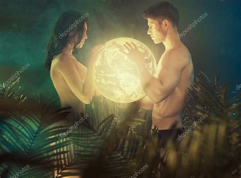 Nude Couple Holding The Shiny Earth Stock Photo Konradbak
