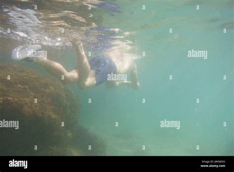 Man swimming underwater Stock Photo - Alamy