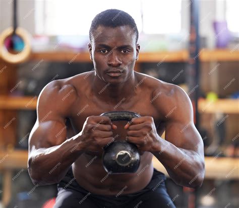 Premium Photo | Black man with kettlebell in gym fitness and focus with