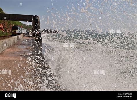 Waves Crashing Against The Seawall At Rockstone Bridge Dawlish As A